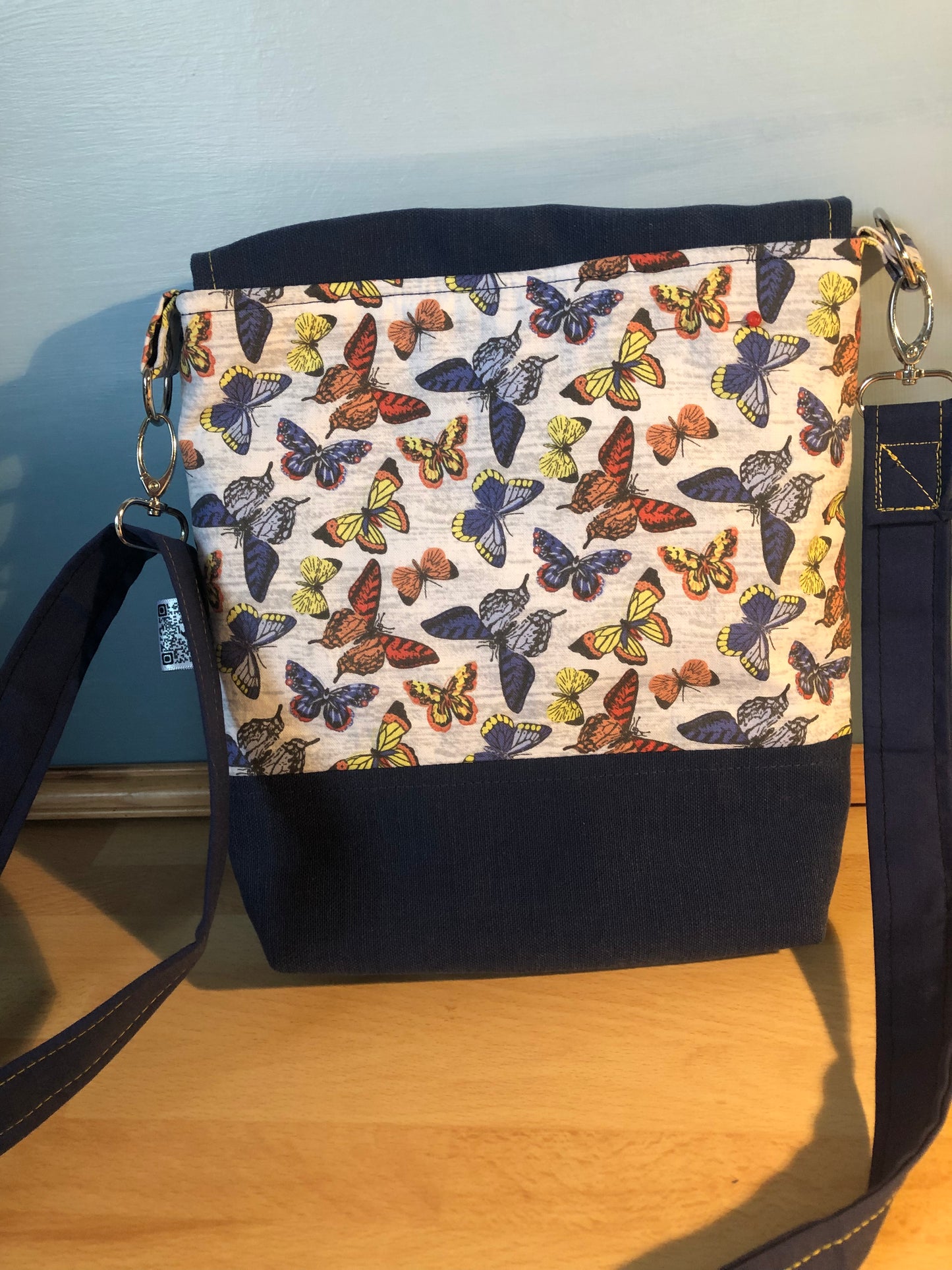 Blue butterfly cross body bag with detachable strap