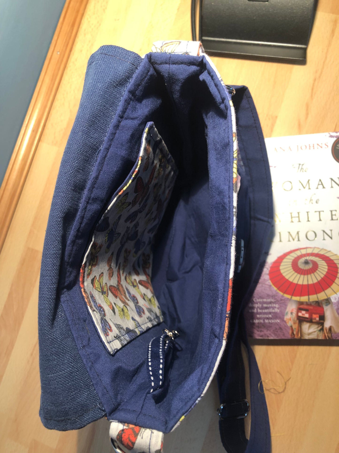 Blue butterfly cross body bag with detachable strap