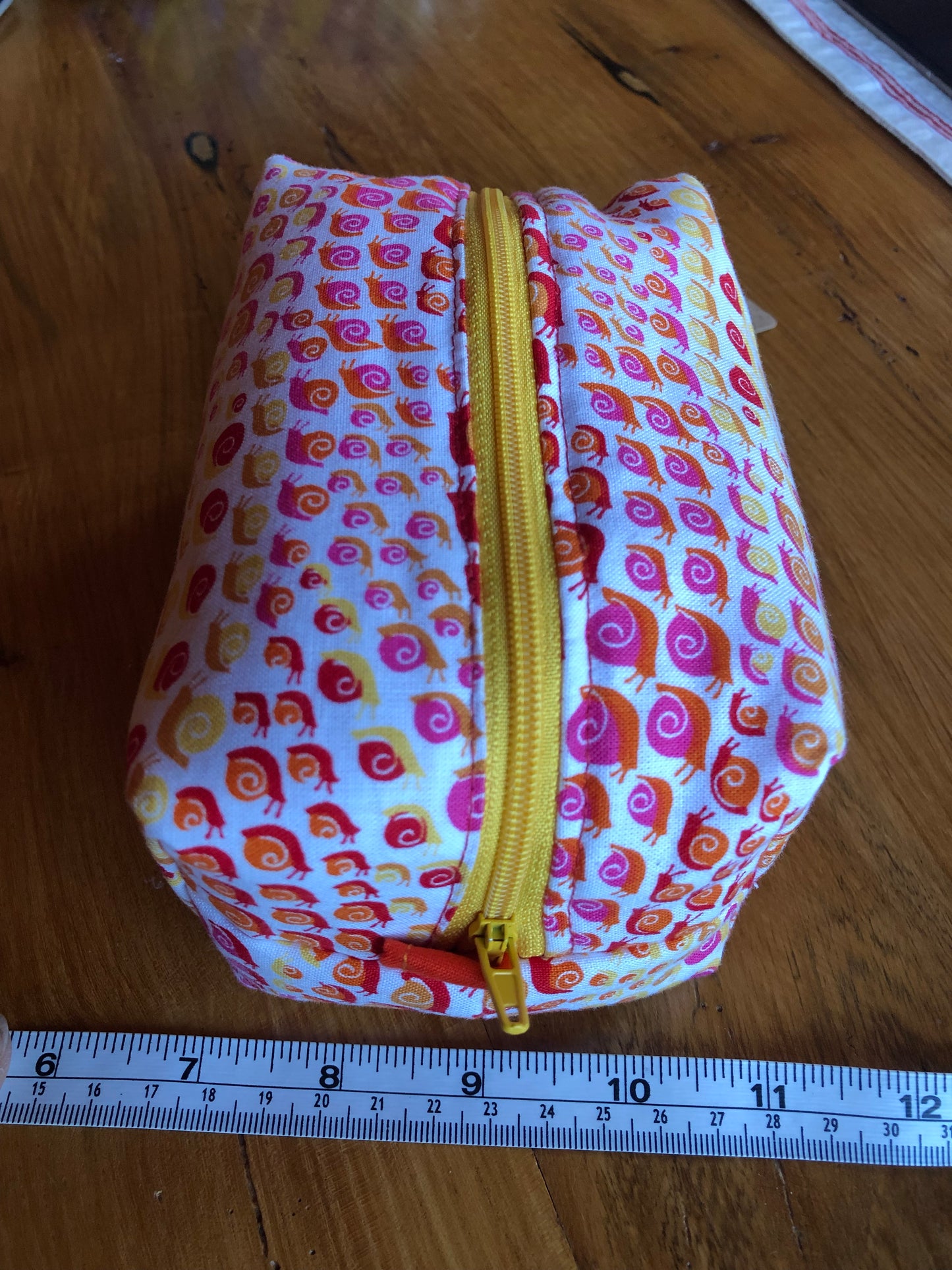 orange, yellow and red, snail pattern cosmetic bag