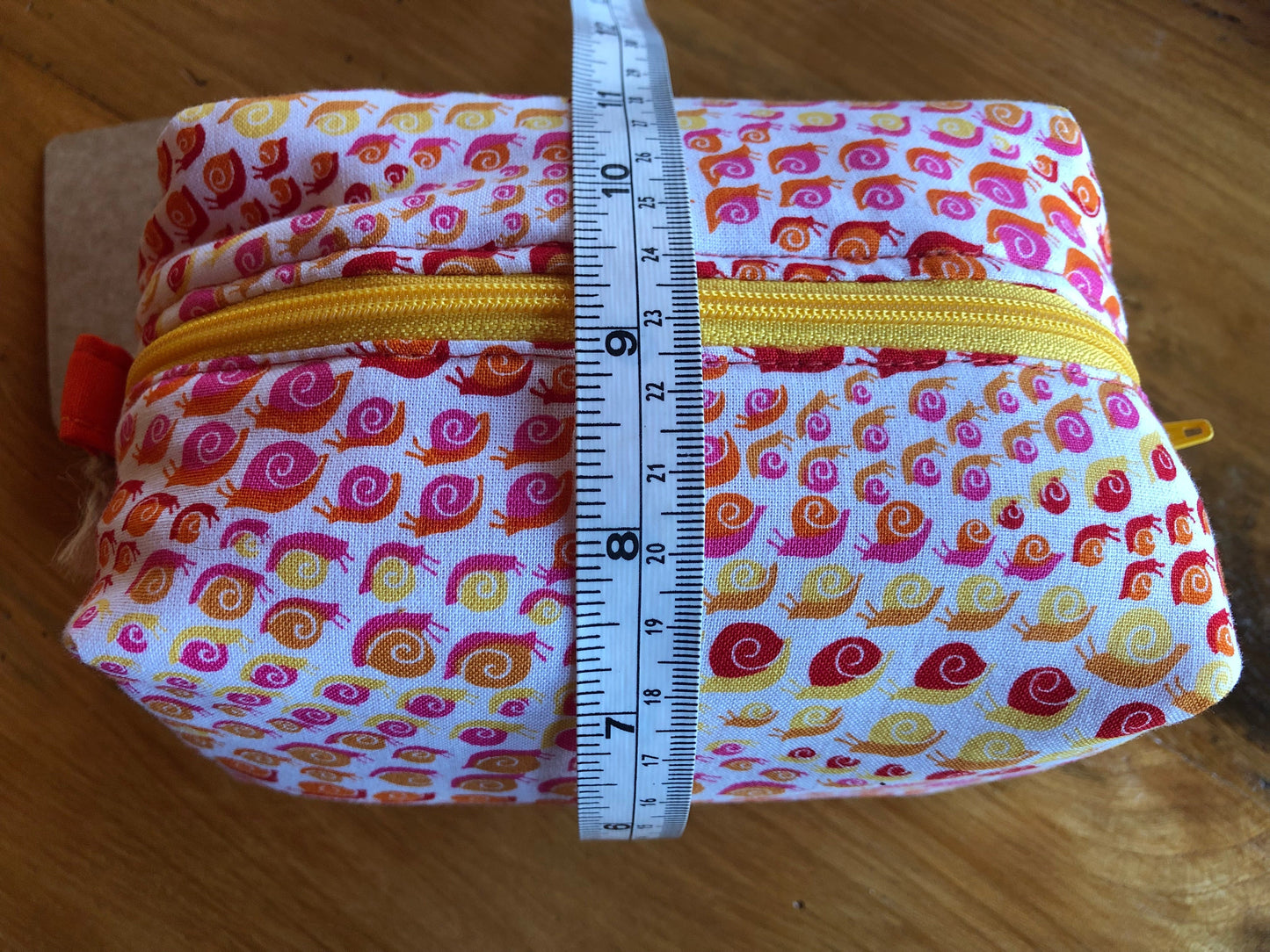 orange, yellow and red, snail pattern cosmetic bag