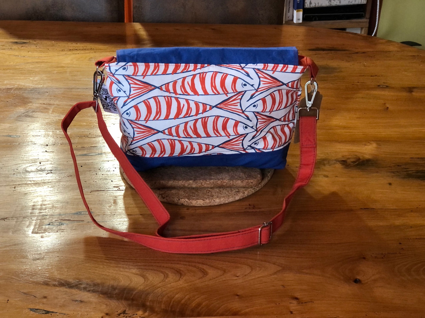 orange blue and white fish shoulder bag with button fastening