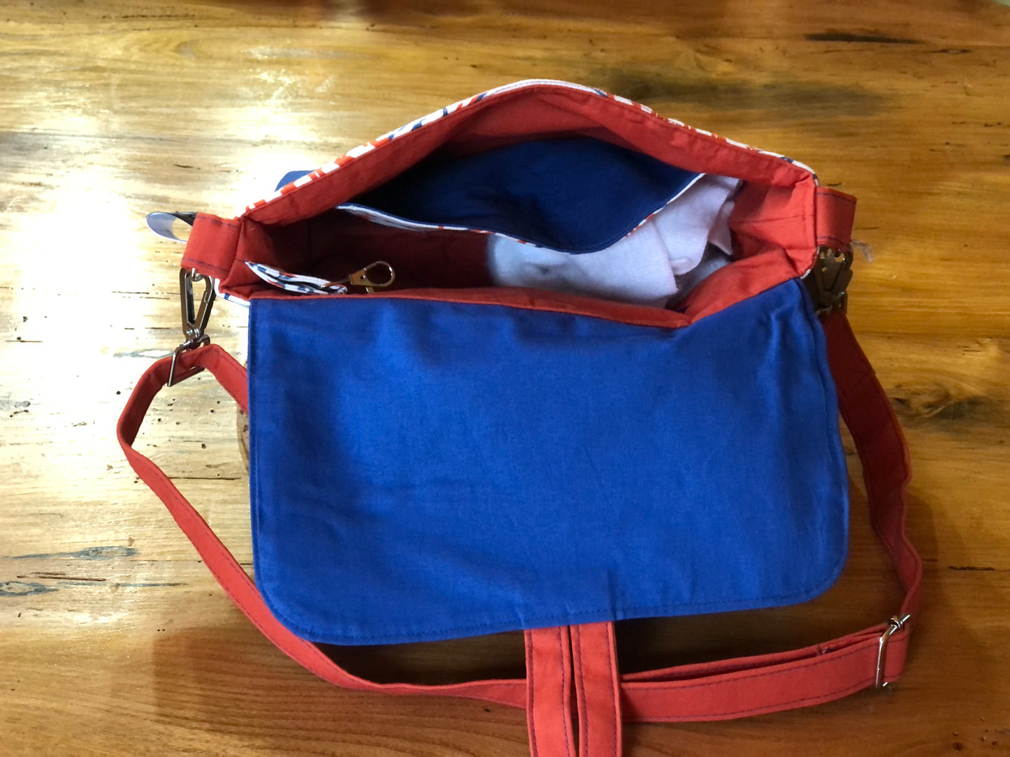 orange blue and white fish shoulder bag with button fastening