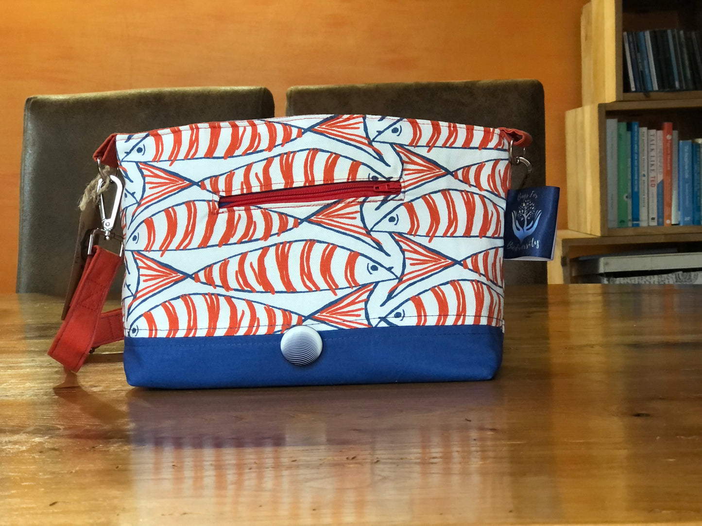 orange blue and white fish shoulder bag with button fastening