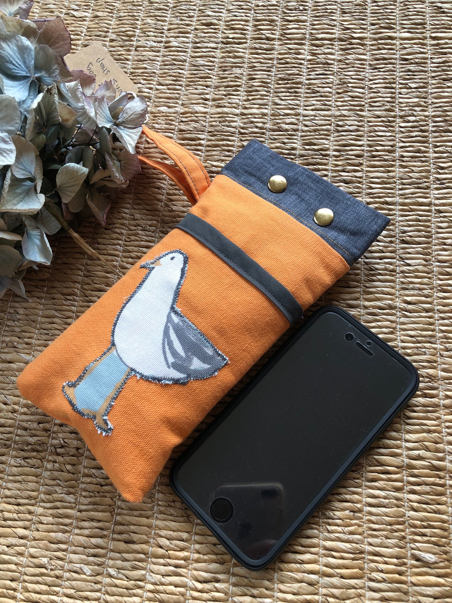 orange and charcoal seagull phone bag with wrist strap and carabina fastening